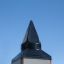 Spire of the Tintagel playground castle against a clear blue sky.