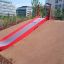 Red Slide installed on a playground hill.