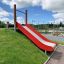 Red slide on grassy playground, Hill Slide SL90.