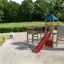 Challenger- Aztec wooden playhouse in a park with children playing