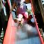 Child enjoying slide on Challenger- Aztec wooden playhouse