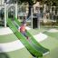 Child playing on Hill Slide SL120 outdoor playground equipment.