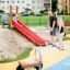 Children playing on Hill Slide SL150 at a playground.