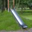 Outdoor playground with Hill Slide SL150 on grassy slope.