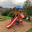 Playground with Logo Tower playhouse featuring a slide.