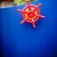 Red ship wheel on a blue play structure at a playground.