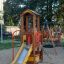 Dixie playhouse with slide in a playground