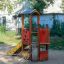 Dixie playhouse with slide in a playground setting