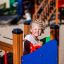 Child playing in Smart playhouse with slide.