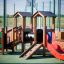 Smart playhouse with slide in an outdoor playground setting