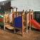 Rubik playhouse with slide in a playground.