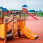 Rubik playhouse with slide in outdoor playground.