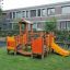 Rubik playhouse with slide in a playground.