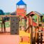 Rubik playhouse with slide in a colorful outdoor playground.