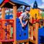 Child playing on Rubik playhouse with slide at the playground.