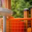 Rubik playhouse with slide featuring an orange fence looking excited.