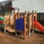 Rubik playhouse with slide in a playground.