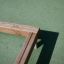 Wooden 'Balance' frame placed on green surface.