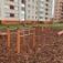 Parallel bar outdoor exercise equipment in a playground area with woodchip ground cover