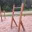 Wooden outdoor training rack with a ladder structure in a park.