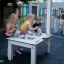 Children playing with Sand & Water Play Table II at a playground.