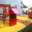 Little Jungle single slide playground with wooden structures and climbing nets.