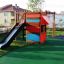 Little Jungle single slide with a black slide and colorful wooden play structure.