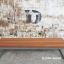Kyoto bench made of exotic wood with metal frame against a rustic wall