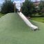 Hill Slide STS 180 on a green artificial hill in a park setting