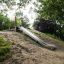 Outdoor slide Hill Slide STS 210 surrounded by trees and greenery.