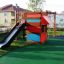 Child playing on Climbing Kiosk playground equipment with slide.