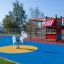 Climbing Kiosk playground structure with slide and activity panels on colorful play surface.