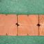 Wooden sand edging pegs in a row.