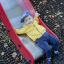 Child enjoying the Fire-station playhouse with slide.