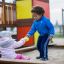 Two children playing in the All accessible sandbox.