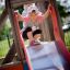 Child on a Single Swing with Tower single slide.