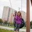 Child playing on Single Swing with Tower single slide in a playground.