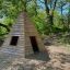Wigwam wooden house in a forest play area
