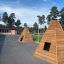 Wigwam wooden house on a school playground with trees in the background
