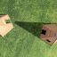 Wigwam wooden house playground structures on grass.