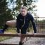 Man using Double Jump Bars outdoor playground equipment.