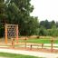 Outdoor playground equipment with Double Jump Bars and climbing net.
