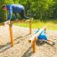 Two people exercising on Double Jump Bars in an outdoor fitness park.