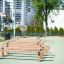 Outdoor fitness equipment Hip Hop in a playground setting with wooden parallel bars.