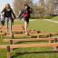 Children playing on the Hip Hop wooden obstacle course in a park.