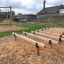 Outdoor playground with wooden climbing structure and balance beams from Hip Hop.