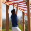 Boy playing on Horizontal Ladder Large in outdoor playground.