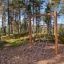 V-shape Net Large climbing net in a forest playground setting