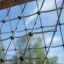 V-shape Net Large climbing net close-up against blue sky.