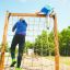 Children climbing on a V-shape Net Large climbing net in a park.